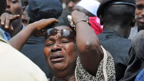 A woman cries in front of the Conakry great mosque after the stadium massacre - October 2009