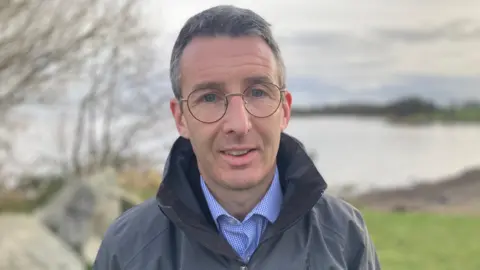 Andrew Muir in front of Lough Neagh