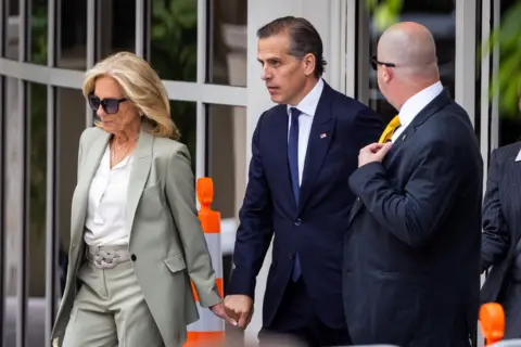 Jill Biden and Hunter Biden hold hands as they exit a courthouse