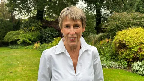 Gill Haggarty Arturo Fanconi's great-niece Gill Haggarty standing in a garden