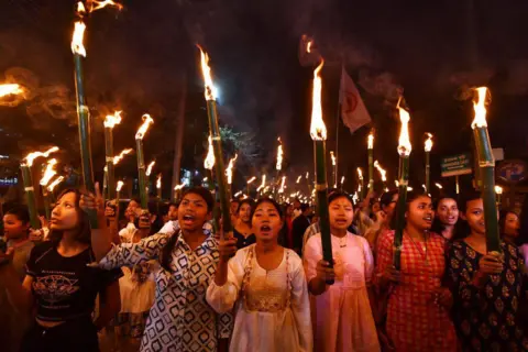 AFP via Getty Images Members of the All Assam Students' Union (AASU) take part in a torch rally as they protest against the implementation of the Citizenship Amendment Act (CAA) in Guwahati on March 12, 2024. India's interior ministry said March 11 it was enacting a citizenship law that critics say discriminates against Muslims, just weeks before the world's most populous country heads into a general election. (Photo by Biju BORO / AFP) (Photo by BIJU BORO/AFP via Getty Images)
