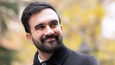 Getty Images New York City Mayor-Elect Zohran Mamdani wears a coat outside.