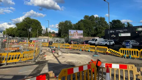 A general view of roadworks and an area that has been blocked off by yellow barriers