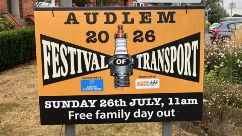 A large sign saying Audlem 2026 Festival of Transport Sunday 26th July 11am