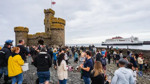 Douglas City Centre Management Crowds on the island with a tower with the ferry in the background