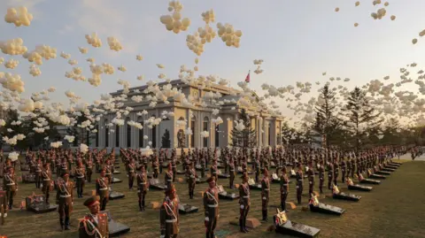 KCNA via Reuters Balloons fly as soldiers stand in position next to memorial stones during the opening ceremony of the Memorial Museum of Combat Feats at the Overseas Military Operations honouring North Korean troops killed while fighting for Russia in the war against Ukraine, in Pyongyang, North Korea, April 26, 2026, in this picture released by North Korea's official Korean Central News Agency. 