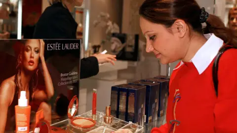 A lady looking at Estee Lauder make up