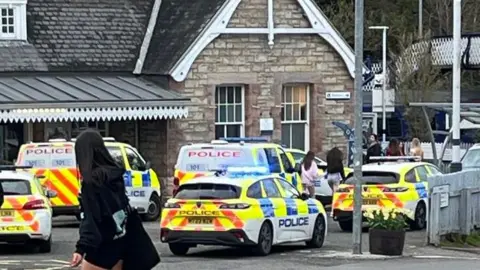 A number of police vehicles outside Aberdour Train Station.