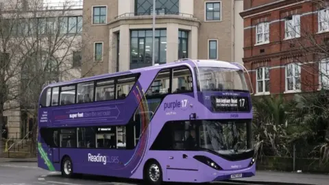 Reading Borough Council Purple Reading Bus stopped at a bus stop in Reading Town Centre