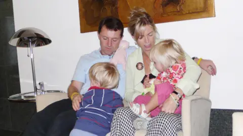 PA Media The family in 2007 in a Faro airport departure lounge preparing to fly back from Portugal after the disappearance of Madeleine