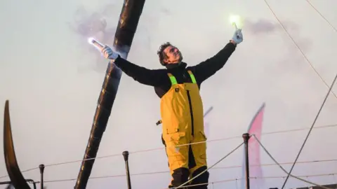 French sailor Charlie Dalin celebrates his victory on board his boat Macif