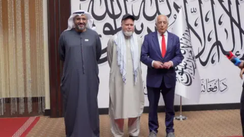 Dennis Coyle with former US ambassador Zalmay Khalilzad shortly after his release by Taliban authorities. 