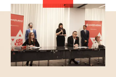 Getty Images A press conference held by the Jewish Labour Movement while Jeremy Corbyn was Labour leader. Adam Langleben is one of his people photographed at the event.