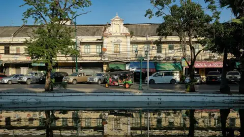 Getty Images An image of a street in Bangkok, Thailand, with tuk-tuks visible