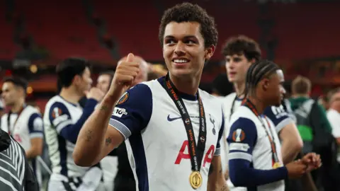 Tottenham's Brennan Johnson with a Europa Cup winners medal