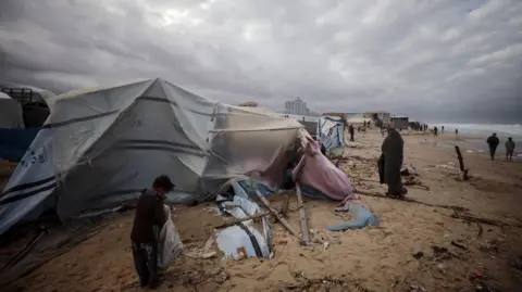 Displaced Palestinians surviving  successful  makeshift shelters connected  Gaza's Mediterranean seashore  adjacent   Deir al-Balah, cardinal  Gaza