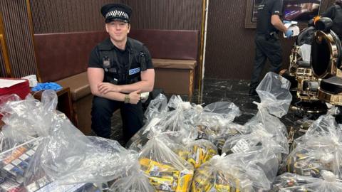 A police officer with illicit cigarettes