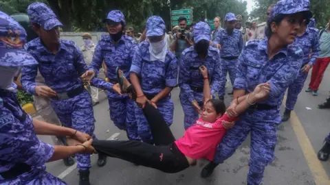 EPA/Shutterstock Indian security personnel detain protesters as they attempt to stop Cockroach Janta Party's(CJP) supporters during a march toward the Parliament in New Delhi, India, 20 July 2026. 