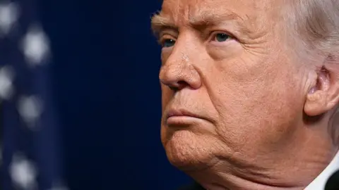 US President Donald Trump looks on as Israeli Prime Minister Benjamin Netanyahu (off frame) speaks to journalists during a joint press conference at Trump's Mar-a-Lago residence in Palm Beach, Florida, on 29 December 29 2025