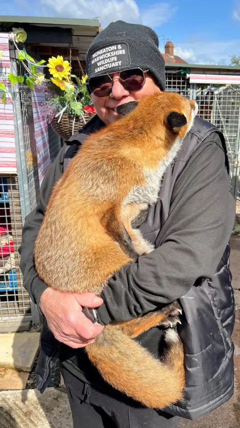 Geoff Grewcock holding one of his resident foxes