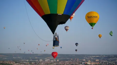 PA Dozens of hot air balloons flying over Bristol.