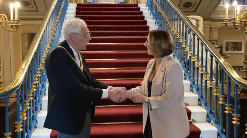 Liverpool Lord Mayor Richard Kemp with fundraiser Alex McCormick, in the gold-trimmed interior of the city's town hall