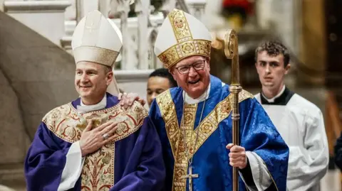 Reuters Archbishop-designate Ronald Hicks (left) and Cardinal Timothy Dolan, outgoing Archbishop of New York