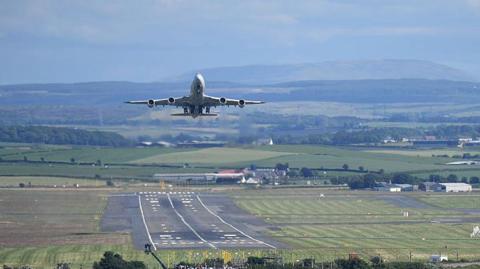 Plane taking off at Prestwick Airport