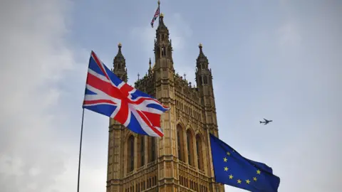 BBC/ Jeff Overs The Union Flag flies next to the EU flag outside one of the towers at the Palace of Westminster.
