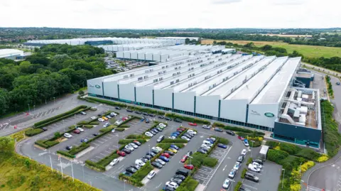 An aerial view of i54, a business park in Wolverhampton. It comprises a series of large warehouse buildings.