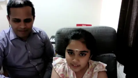 Bodhana Sivanandan with her father during a Zoom call with the BBC