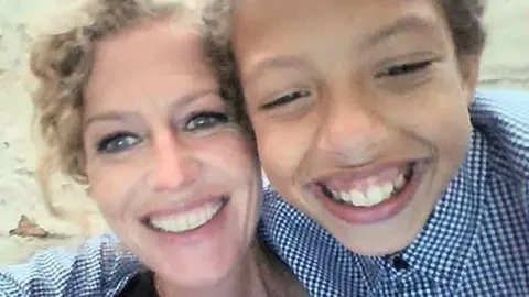 Pacemaker Press Fiona and Noah Donohoe in a selfie. They are right next to each other. Fiona has her hair tied back and has black eye makeup on, she is smiling. Noah is also smiling in the picture, has short dark hair and is wearing a blue and white checked shirt.