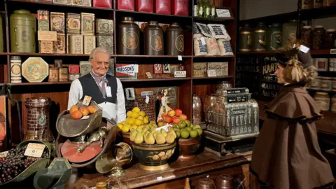 Mannequins in a Victorian shop as part of a historical display in a theme park  