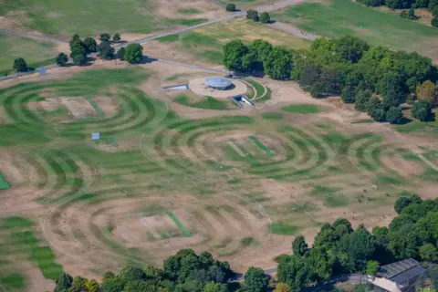 jasonhawkes.com Cricket pitches mowed in circles with green lines