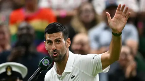 Novak Djokovic waves to the Centre Court crowd