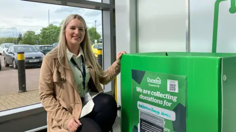 BBC Lianne Heaps-Warby with a collection bin at Dunelm in Cheltenham