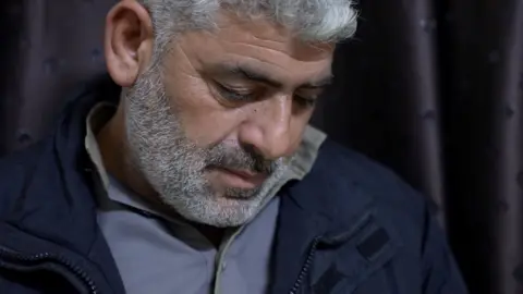 BBC A tearful old man looks down. A tear appears on his cheek.