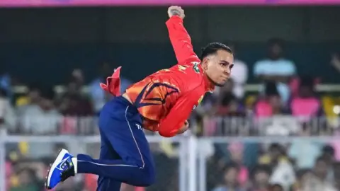 Rahul Chahar delivers a ball during the Indian Premier League (IPL) T20 cricket match between Rajasthan Royals and Punjab Kings 