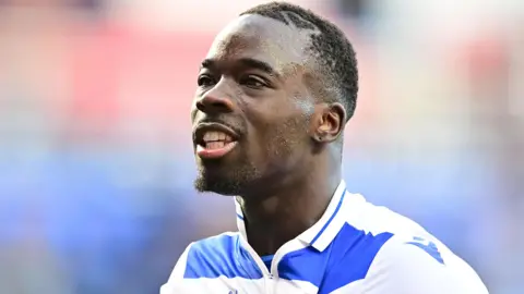 Amadou Mbengue celebrates a victory for Reading over Northampton Town