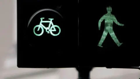 A cycle and pedestrian crossing showing the green light. 