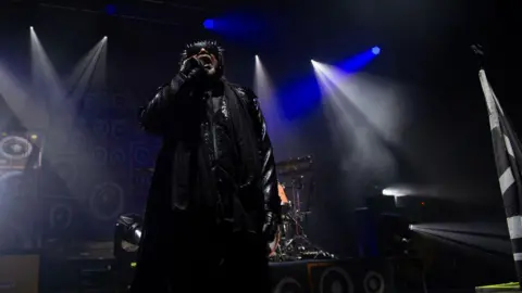 Getty Images Benji Webbe on stage with Skindred.