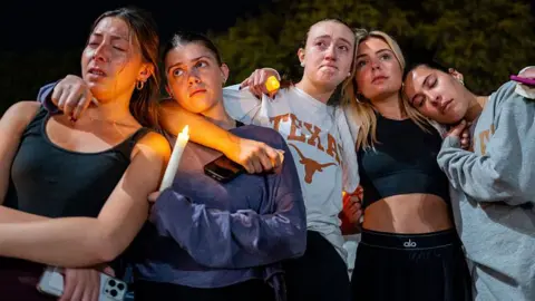 Students gather for a candlelight vigil for the victims of Sunday's mass shooting