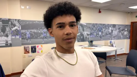 Jobseeker Leo looking at the camera. He is wearing a white T-shirt