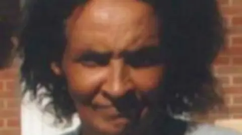 Missing People A headshot of Lorraine. She is smiling at the camera, her black hair is loose and reaches her chin. 