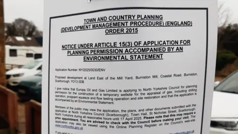 LDRS/Anttoni James Numminen Photo of a sign, reading: "Town and country planning (development management procedure) (England) order 2015. Notice under article 15(3) of application for planning permission accompanied by an environmental statement. Application Number: NY/2025/0030/ENV."
The letter goes on to give notice of the plans described in the article and invites locals to give feedback.