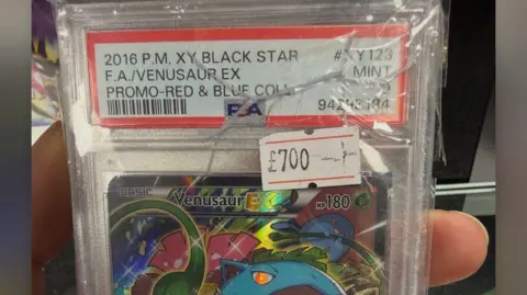 Alex Badham The image shows a Venusaur pokémon Card priced at £700, the case is cracked.