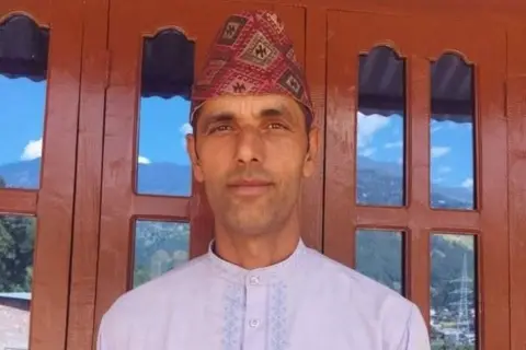 Barun Lamichhane Netra Prasad Lamichhane, a man in traditional dress who escaped the Nepal flash floods.