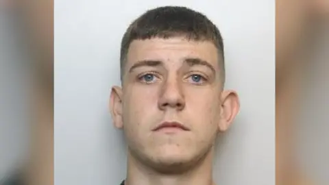 South Yorkshire Police Drew Jarvis is white and has blue eyes and short brown hair