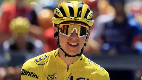 EPA-EFE/REX/Shutterstock Close up of smiling Slovenian rider Tadej Pogacar wearing the yellow jersey, large sunglasses and yellow and black helmet