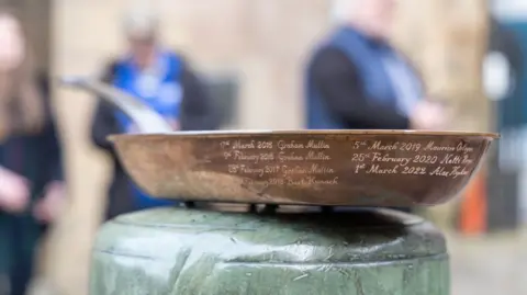 LIVERPOOL BID COMPANY The prize for the event, an engraved pan is shown. It is copper, with the names of previous winners engraved around the sidewall
